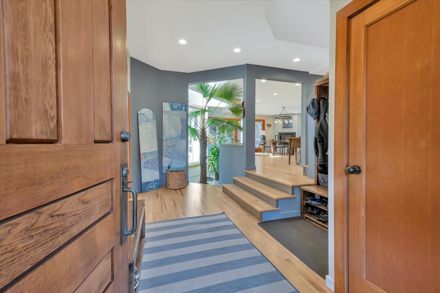 1573 North Rodeo Gulch Road Soquel, CA 95073 - Photo 3 of 40 a hallway with wooden floor windows a chandelier in front of a house