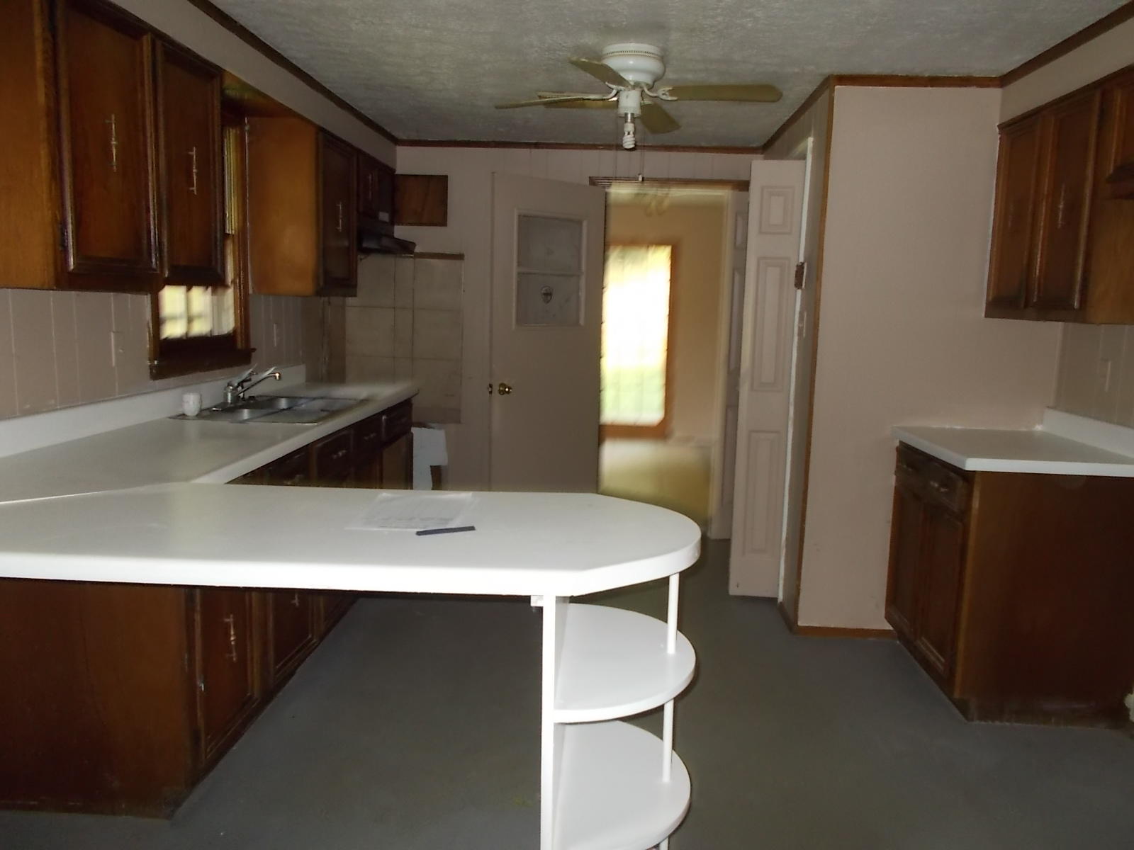 8974 Pine Forest Road Northeast Copper Hill, VA 24079 - Photo 13 of 21 a kitchen with a sink a stove and cabinets