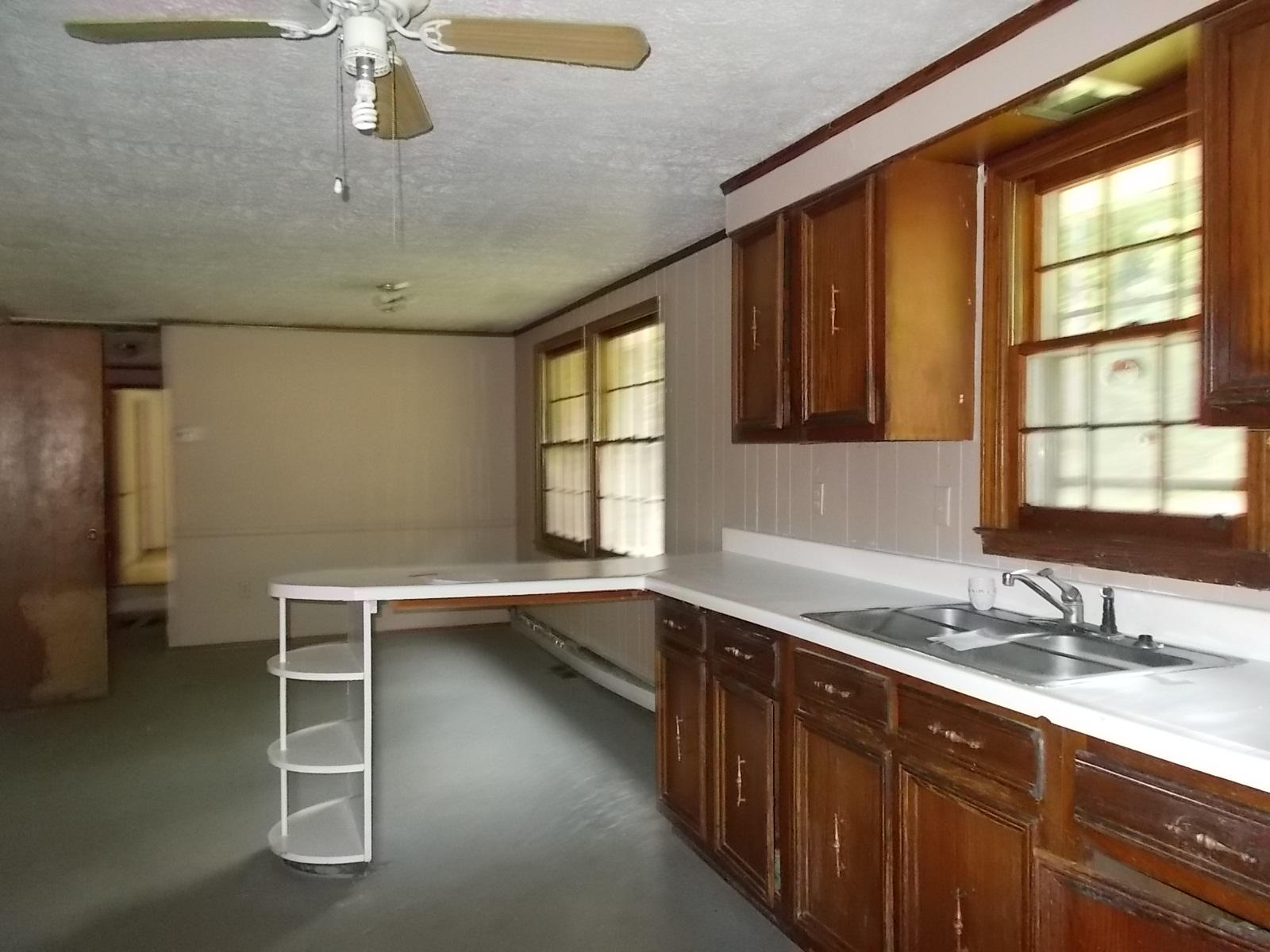 8974 Pine Forest Road Northeast Copper Hill, VA 24079 - Photo 14 of 21 a kitchen with a sink a window and cabinets