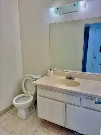 a bathroom with a sink and mirror with toilet