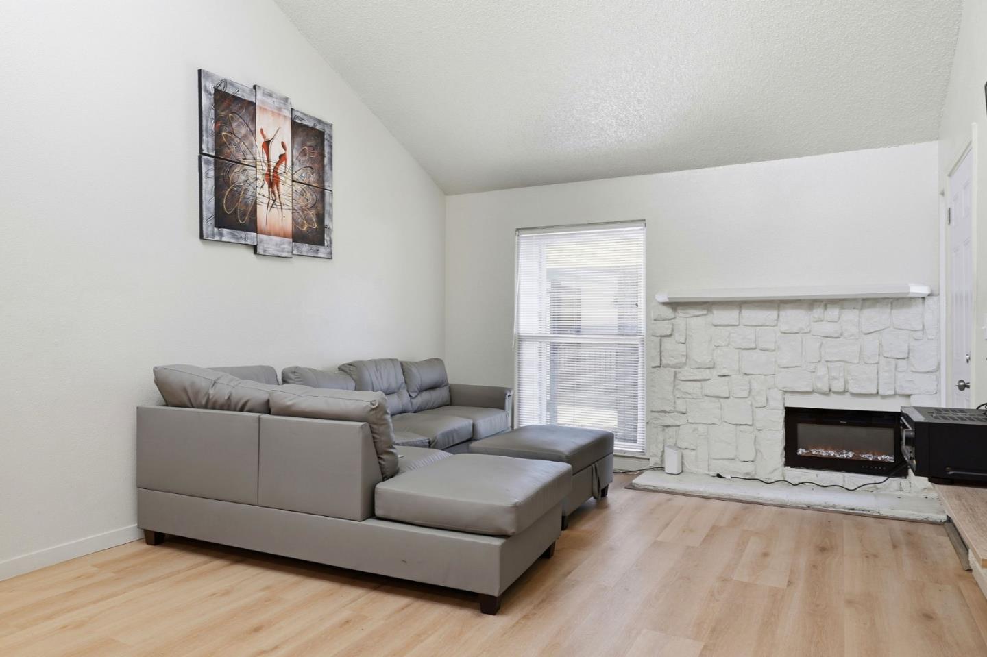 7283 Florin Road, Unit 8 Sacramento, CA 95828 - Photo 6 of 35 a living room with furniture and a fireplace