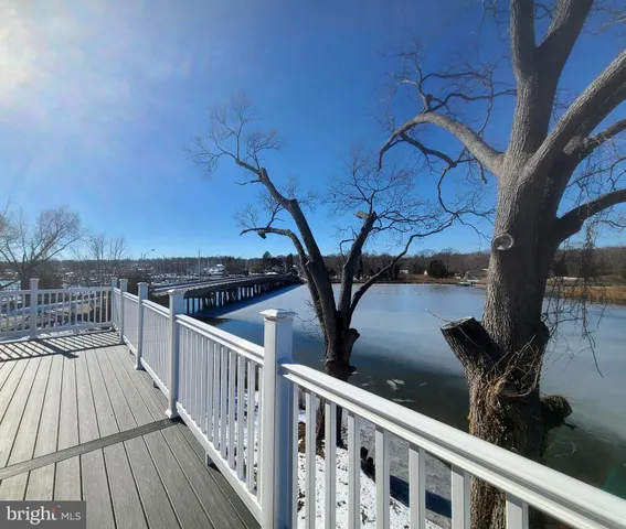 a view of balcony with wooden floor and fence