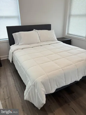 a large bed sitting in a bedroom next to a window