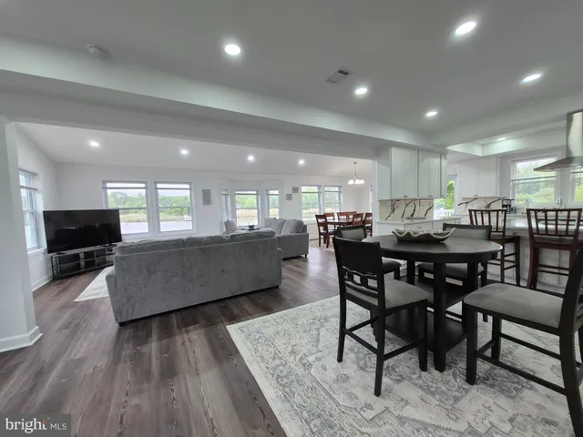a dining room with furniture a wooden floor and a view