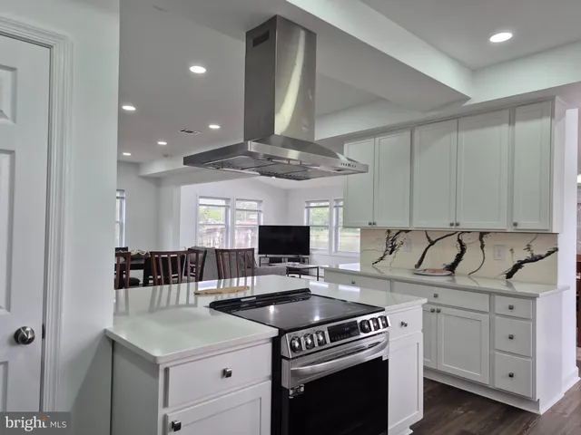 a kitchen with a stove a sink and a refrigerator