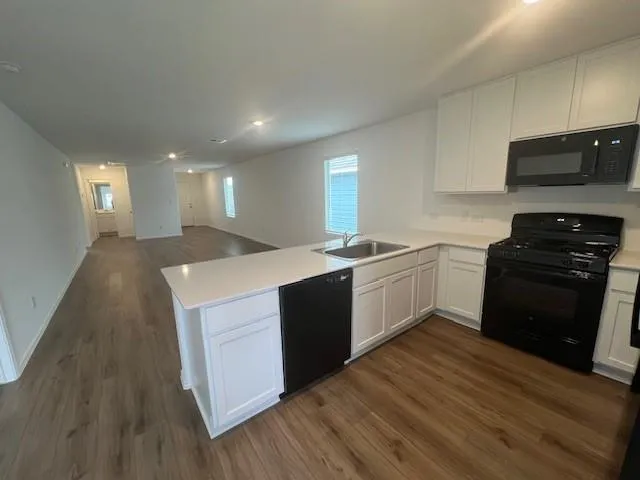 a view of a backyard with wooden fence