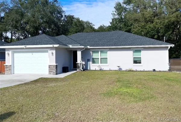 a front view of house with yard and trees
