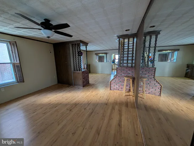a living room with hard wood floors and a wooden floors