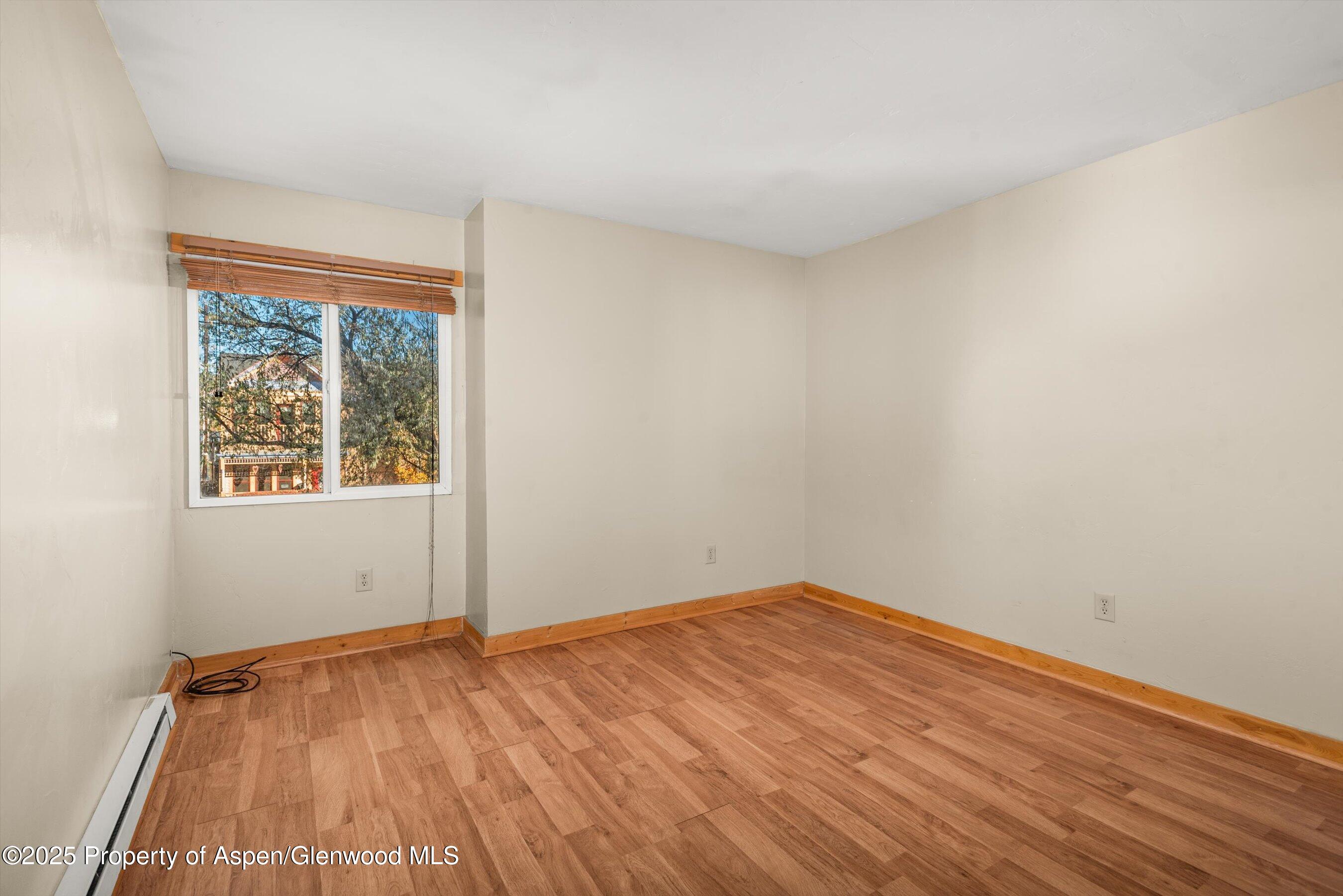 718 Main Street Carbondale, CO 81623 - Photo 15 of 27 an empty room with wooden floor and windows