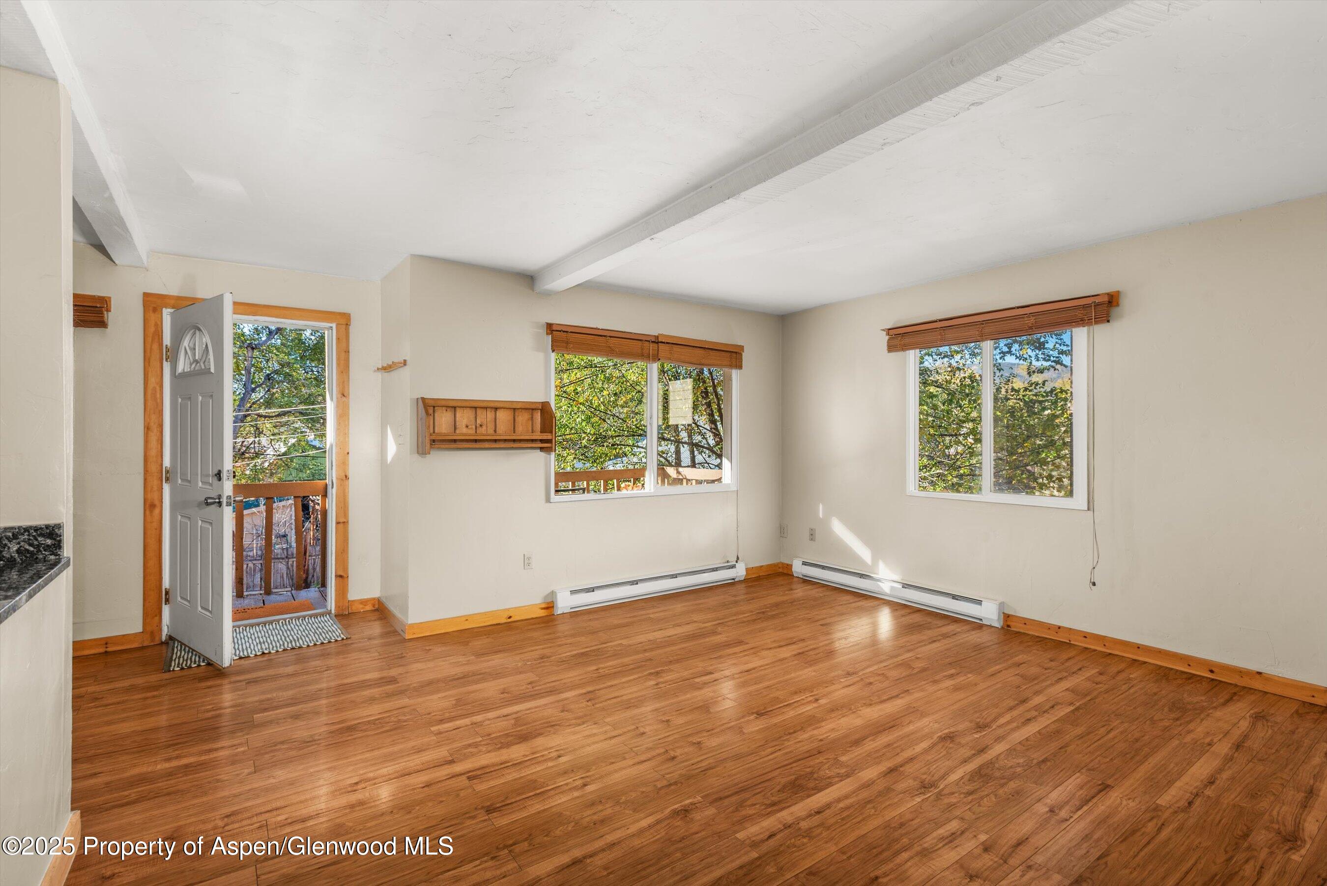 718 Main Street Carbondale, CO 81623 - Photo 9 of 27 a view of an empty room with wooden floor and a window