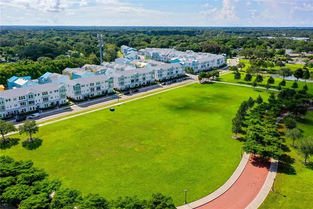 an aerial view of residential houses with outdoor space and garden