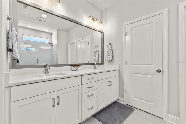 a view of a patio with couches chairs potted plants and a palm tree