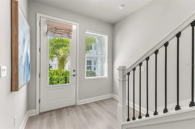 a view of an entryway with wooden floor and door