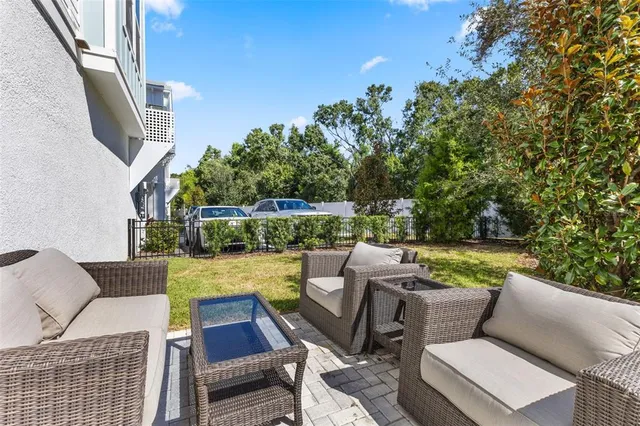 a aerial view of a house with swimming pool and outdoor seating