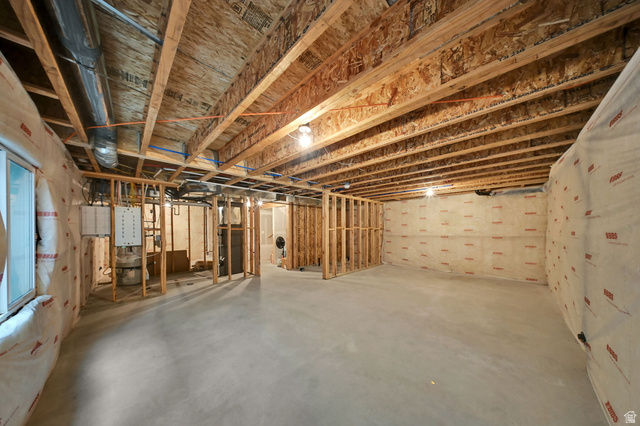 7817 West Kings Top Road Magna, UT 84044 - Photo 26 of 29 Unfinished basement with exposed ceiling joists, concrete flooring, framed wall sections, and insulation-wrapped exterior walls