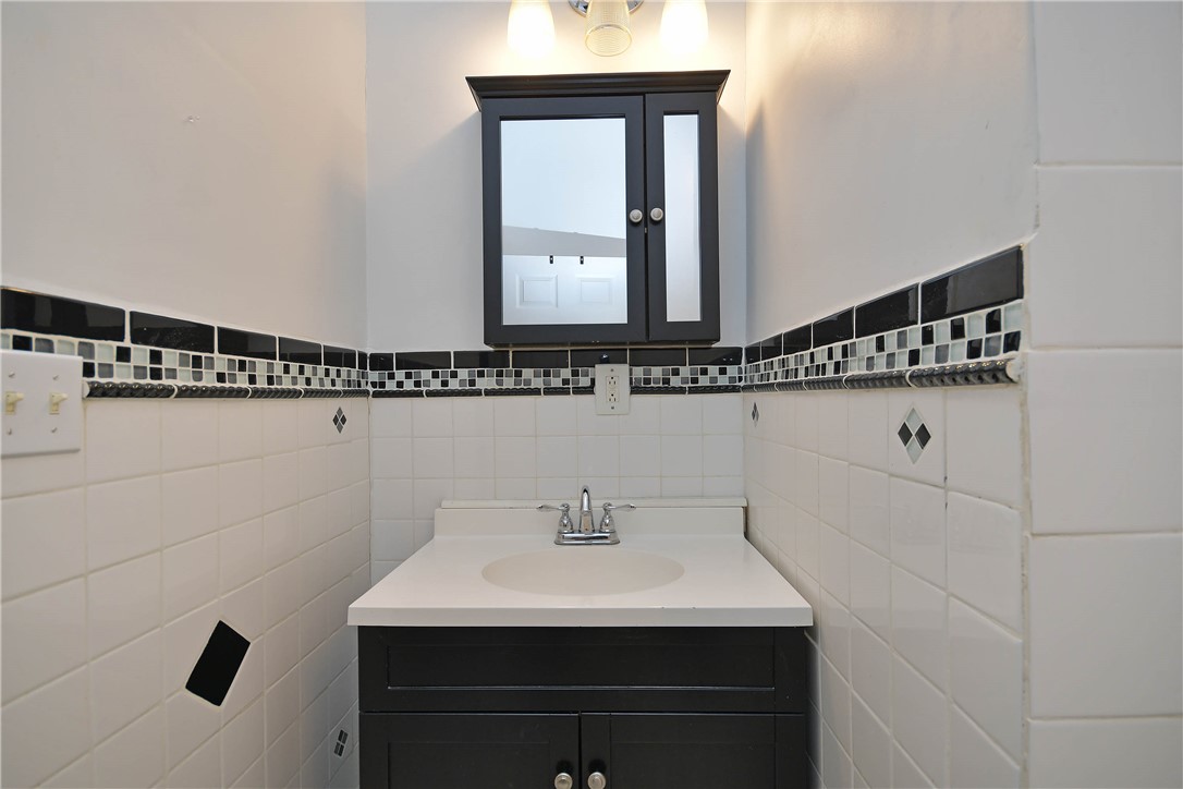 197 Deer Creek Road Easley, SC 29640 - Photo 37 of 50 A well-lit bathroom vanity with a clean, classic black and white tile scheme.