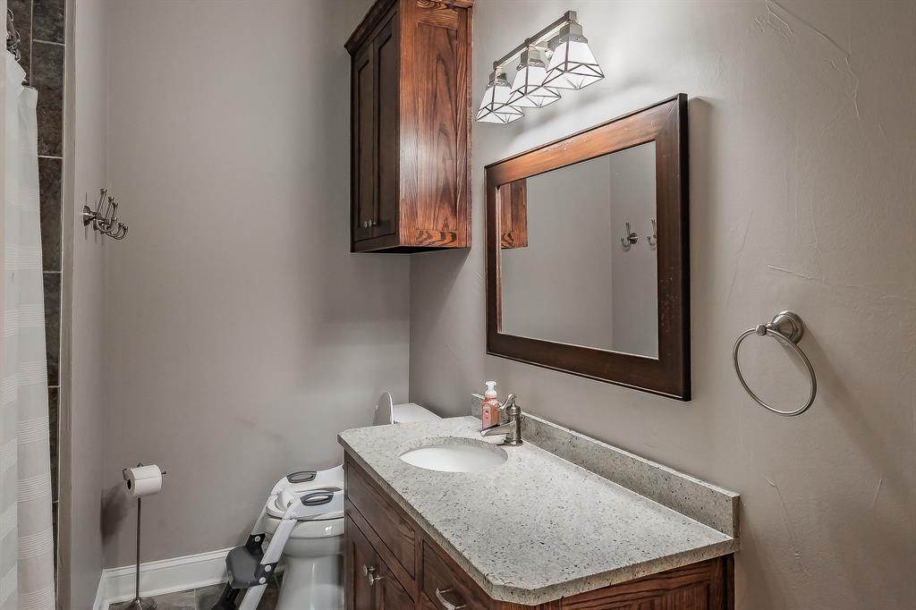 115 Pheasant Run Road Argyle, TX 76226 - Photo 27 of 40 a bathroom with a sink vanity mirror and toilet