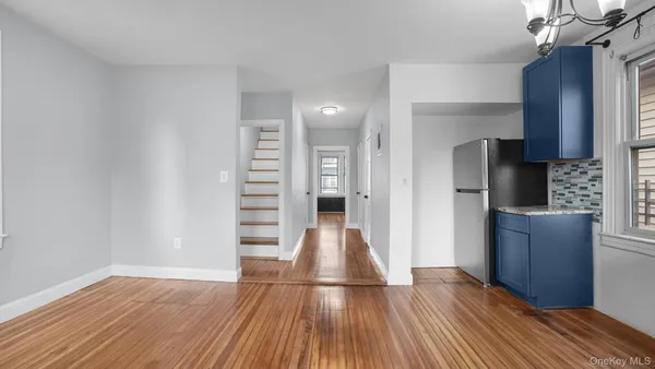 a view of hallway with wooden floor and stairs