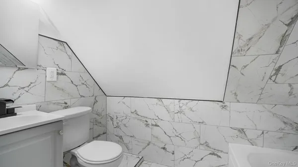 a bathroom with a toilet sink and shower