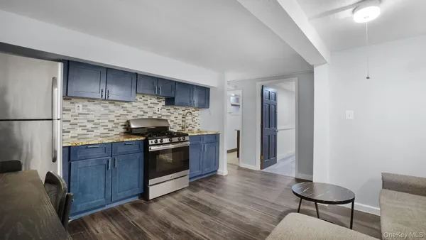 a kitchen with kitchen island granite countertop wooden floors and stainless steel appliances