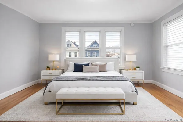 a bedroom with a bed and a large window