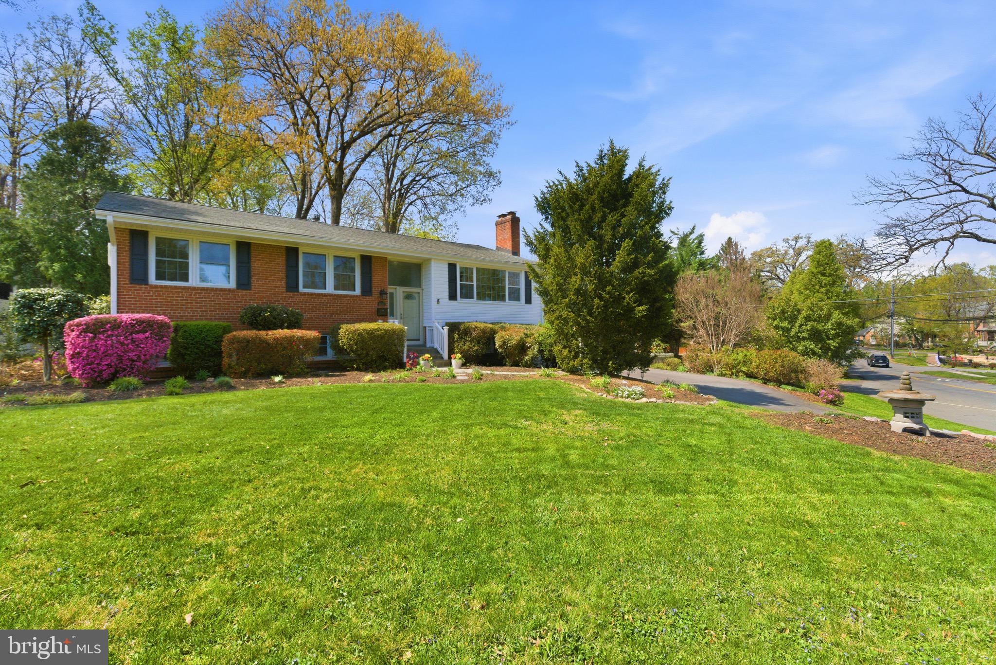 6535 Old Chesterbrook Road McLean, VA 22101 - Photo 1 of 50 a backyard of a house with table and chairs plants and large trees