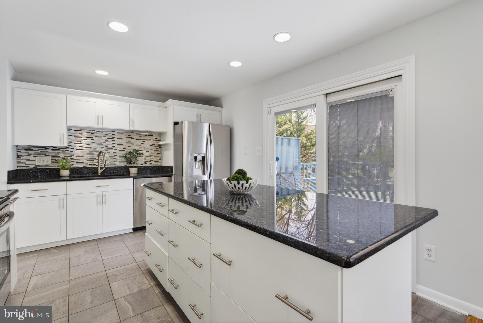 6535 Old Chesterbrook Road McLean, VA 22101 - Photo 20 of 50 a kitchen with stainless steel appliances a sink and cabinets