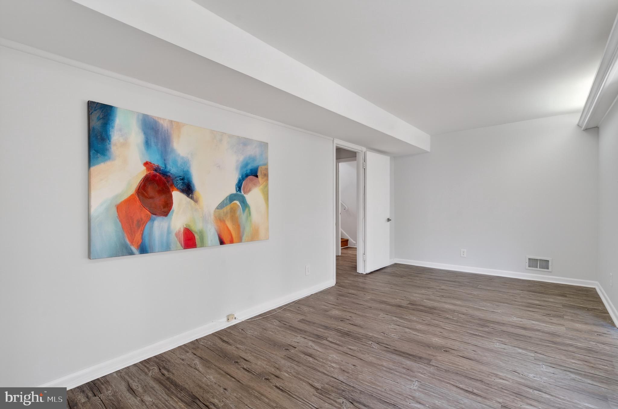6535 Old Chesterbrook Road McLean, VA 22101 - Photo 42 of 50 a view of a room with wooden floor and wall painting