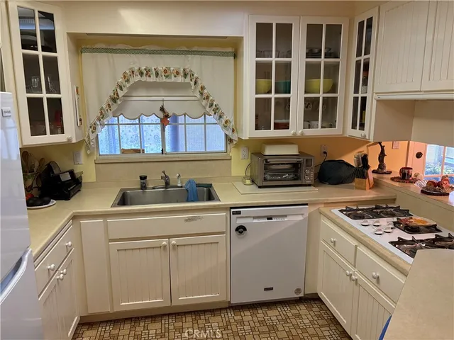 a kitchen with stainless steel appliances granite countertop a stove a sink and a cabinets