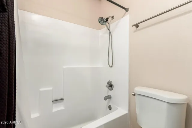 a bathroom with a shower a toilet and a shower