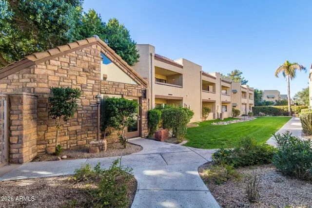 a view of a house with a backyard