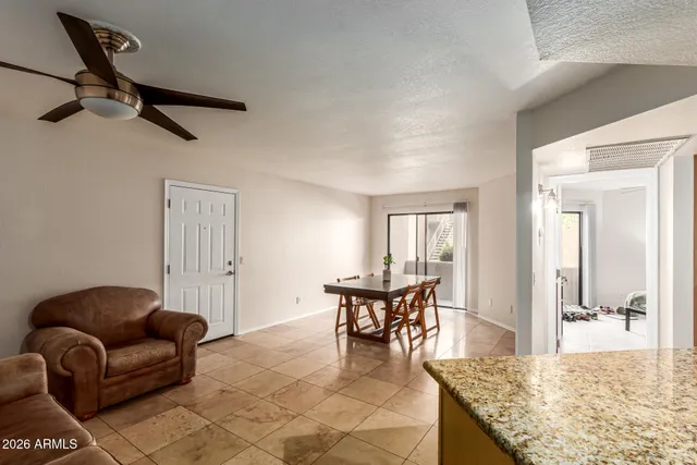 a living room with furniture and a dining table