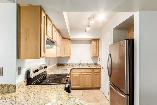 a kitchen with a refrigerator a sink and a stove