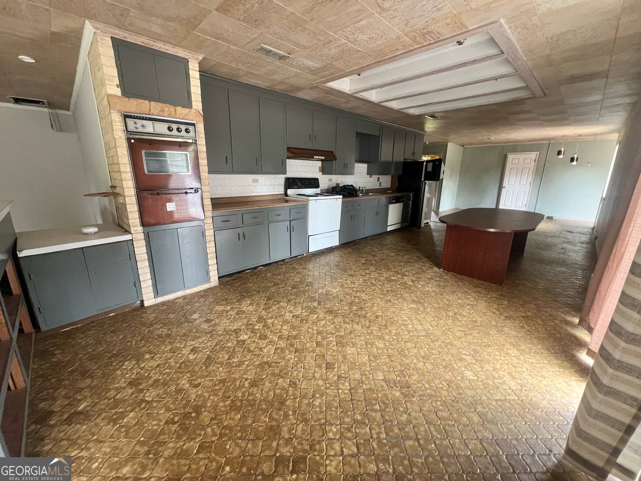 1165 Jaybird Springs Road Chauncey, GA 31011 - Photo 12 of 43 a kitchen with refrigerator and window