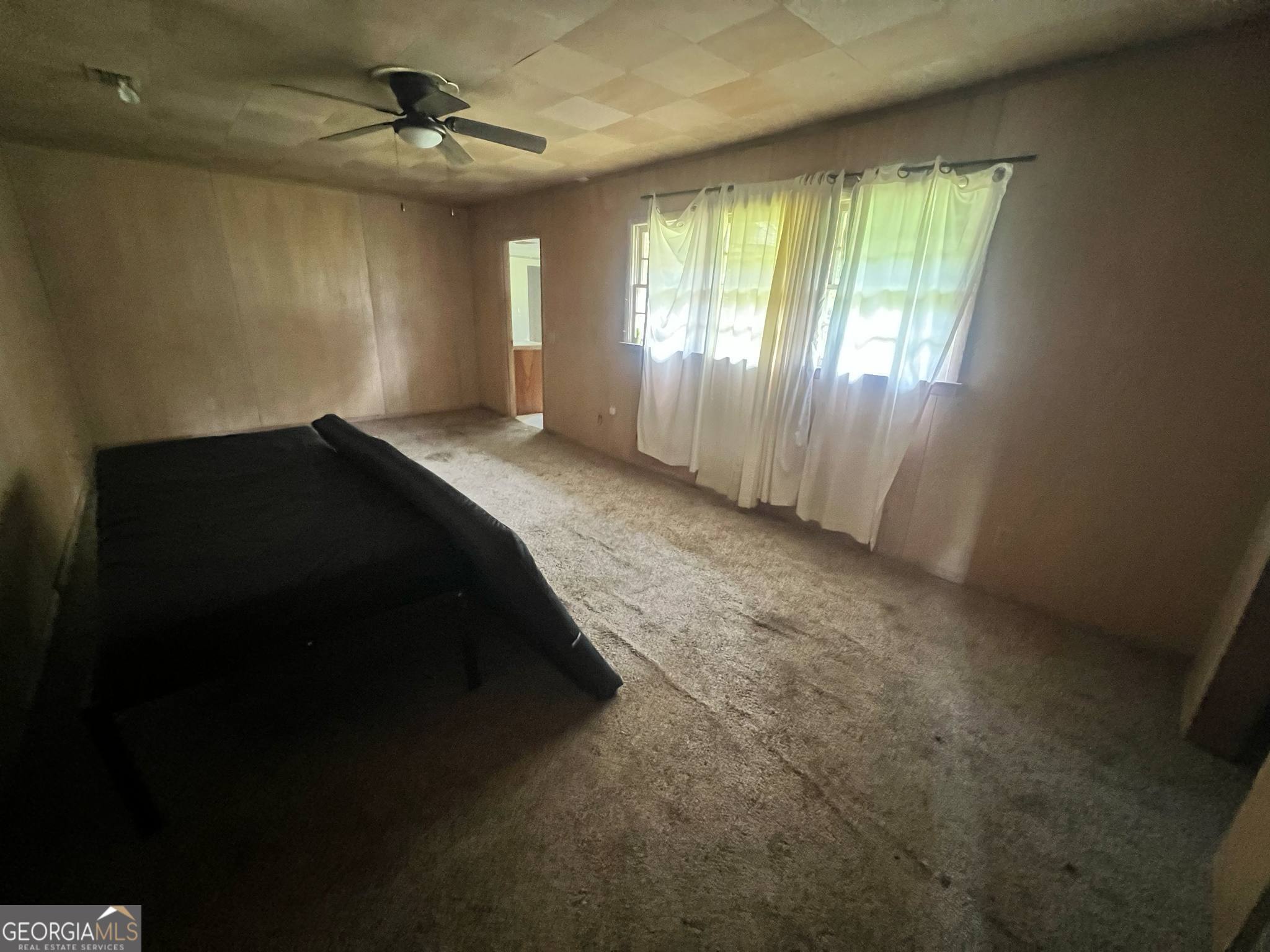 1165 Jaybird Springs Road Chauncey, GA 31011 - Photo 13 of 43 a spacious bedroom with a large bed and a chandelier