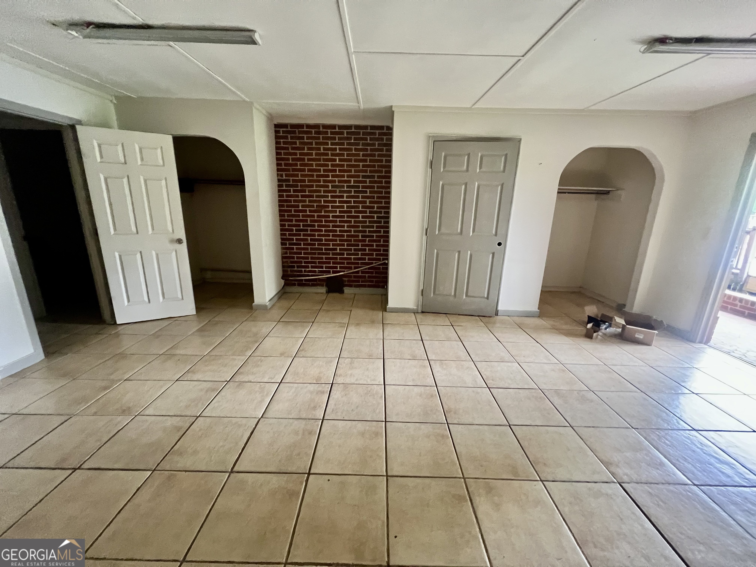 1165 Jaybird Springs Road Chauncey, GA 31011 - Photo 24 of 43 a view of a livingroom with an empty space and a kitchen