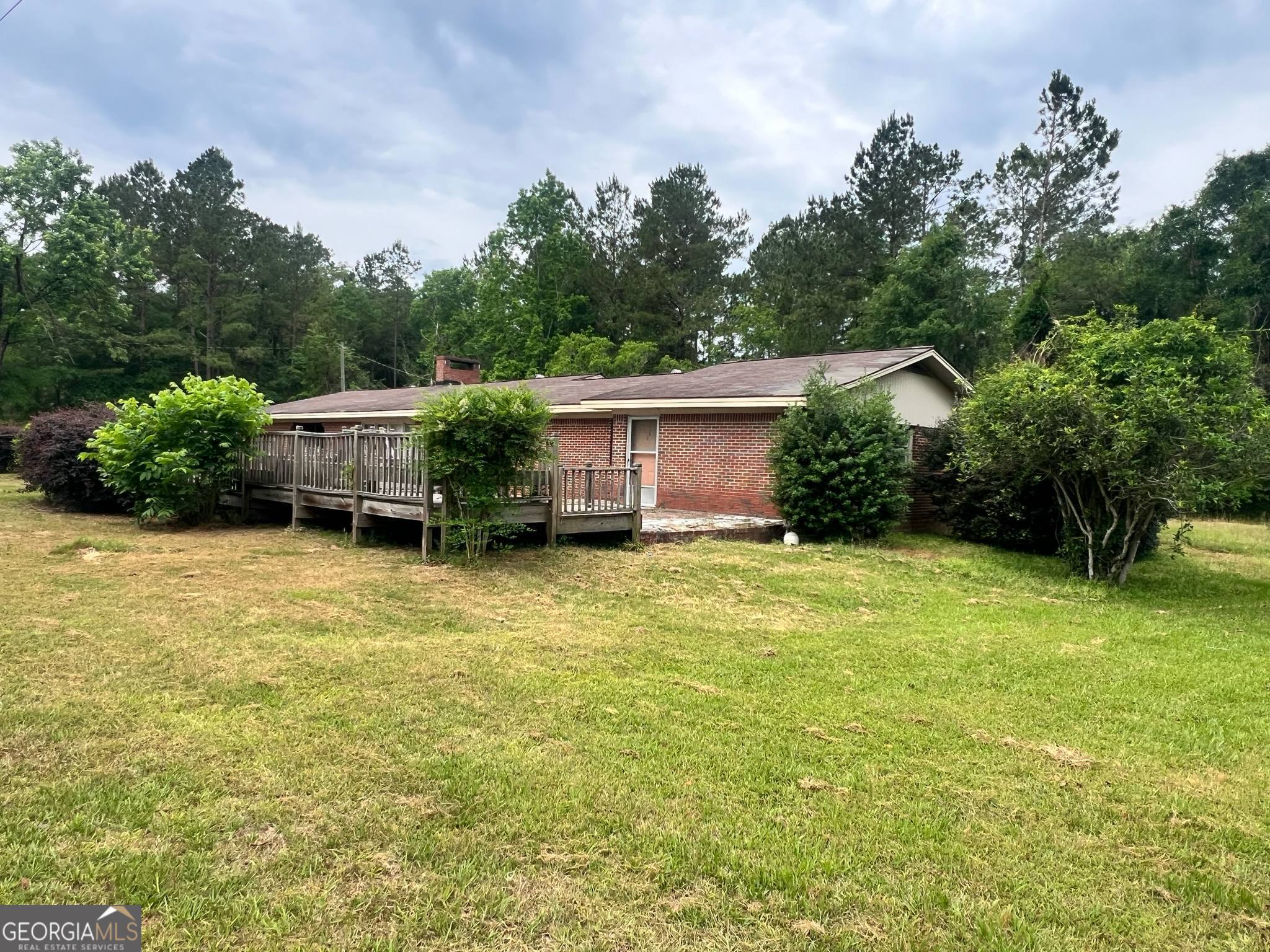 1165 Jaybird Springs Road Chauncey, GA 31011 - Photo 33 of 43 a backyard of a house with plants and wooden fence