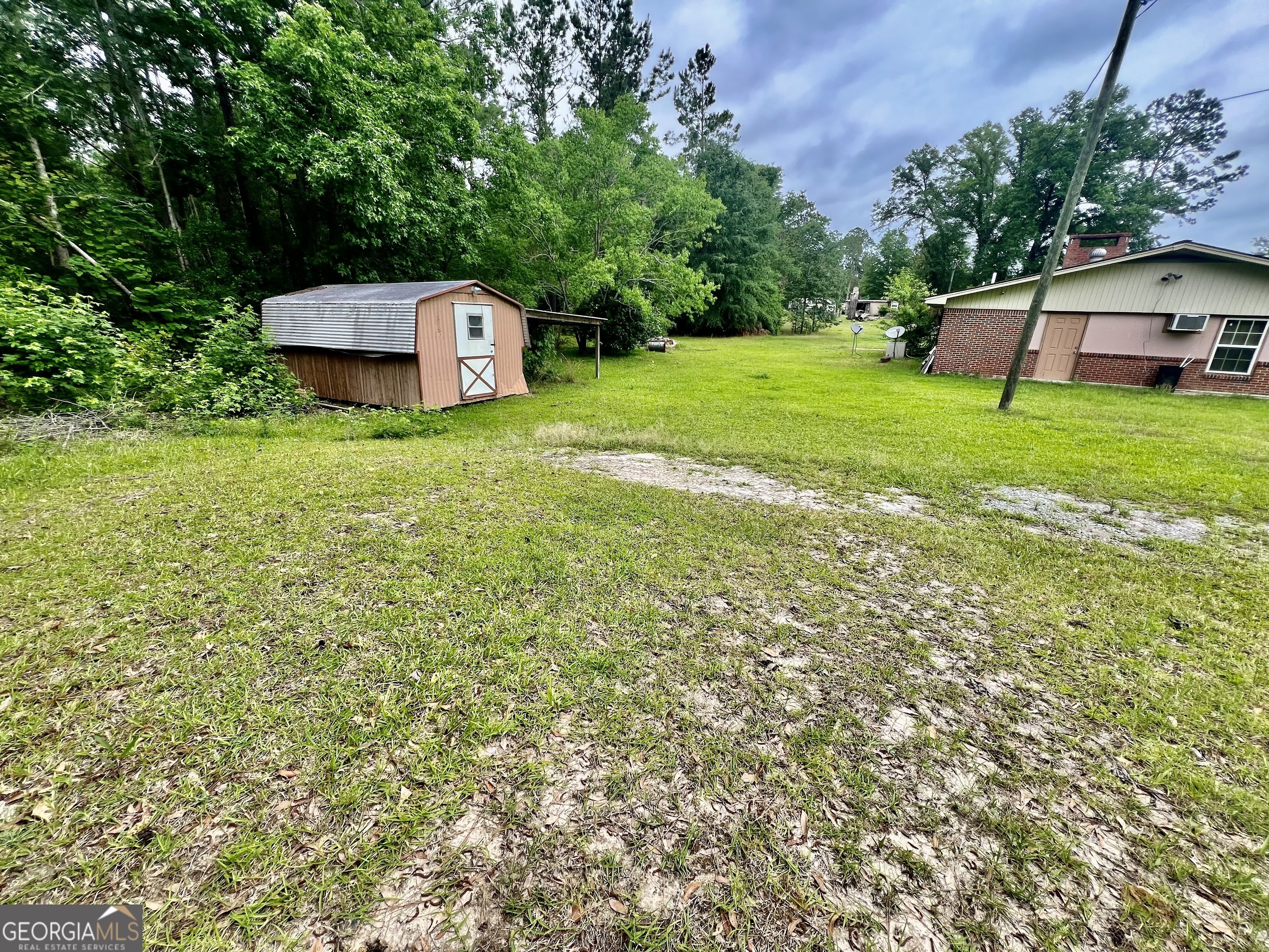 1165 Jaybird Springs Road Chauncey, GA 31011 - Photo 40 of 43 a front view of a house with garden