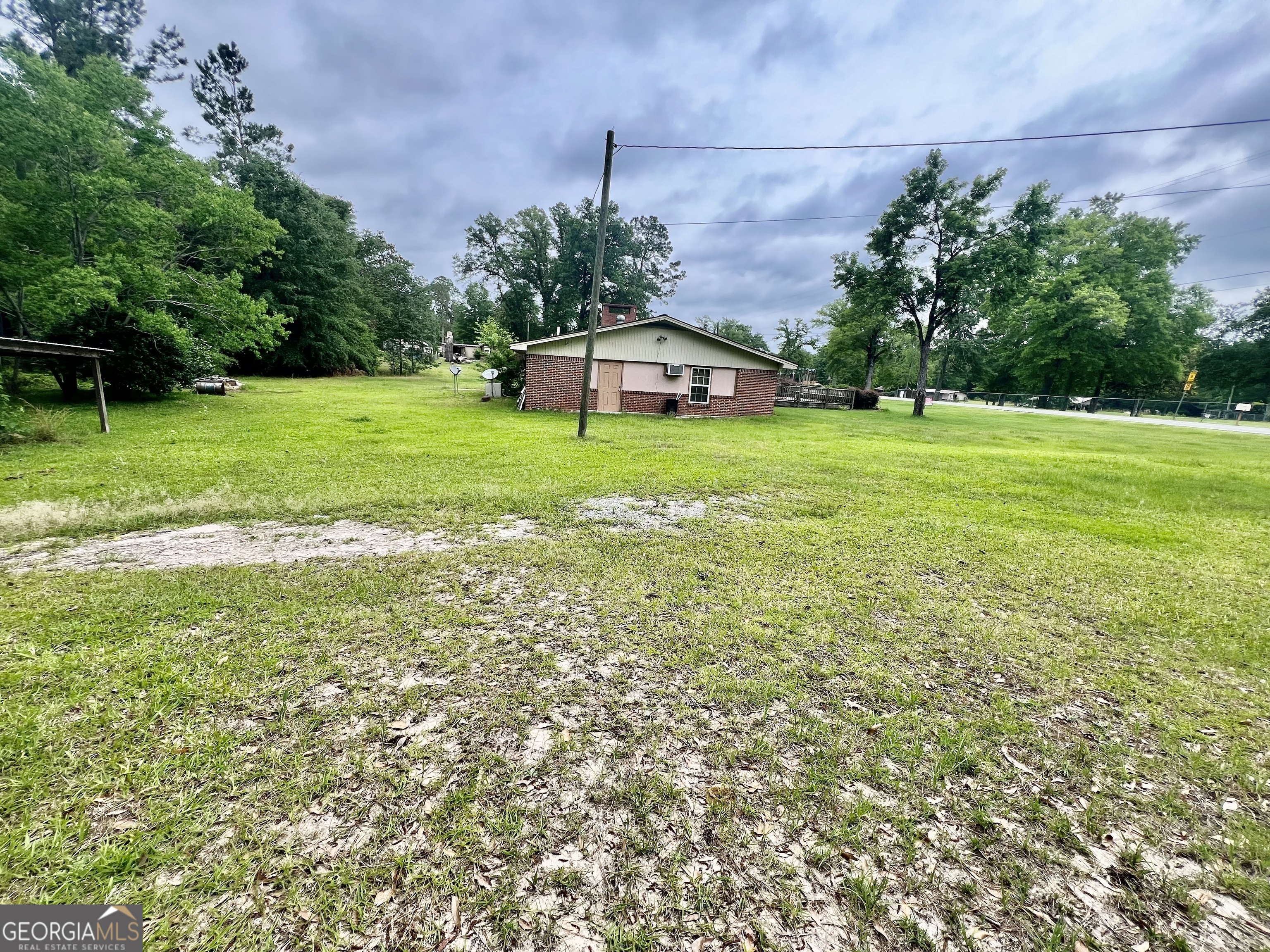 1165 Jaybird Springs Road Chauncey, GA 31011 - Photo 41 of 43 a view of a house with a yard