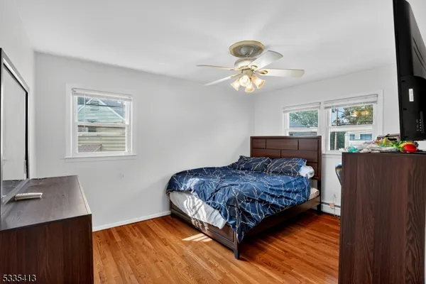 a bedroom with a bed dresser and a window