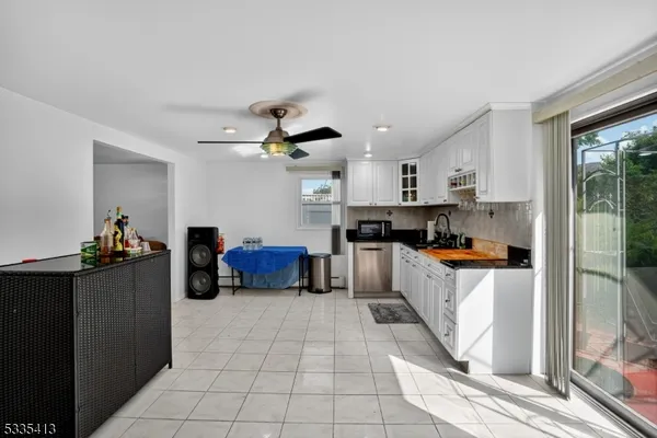 a kitchen with stainless steel appliances a stove a sink cabinets and a refrigerator