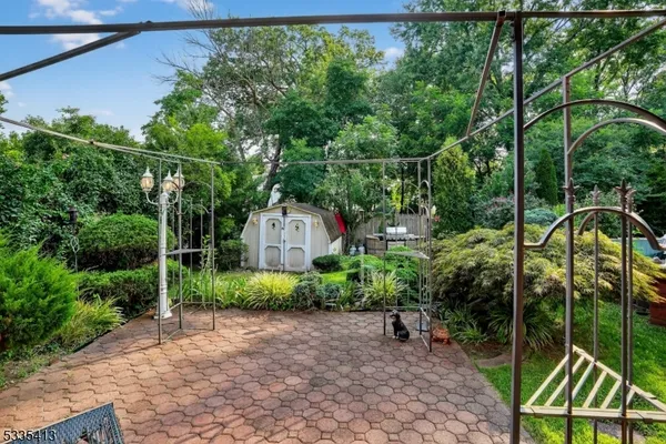 a backyard of a house with lots of green space and glass windows