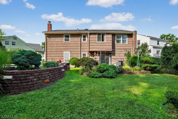 a view of a house with a backyard