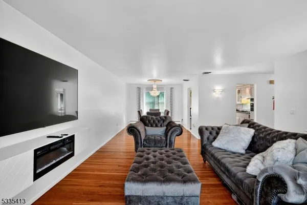 a living room with furniture fireplace and flat screen tv