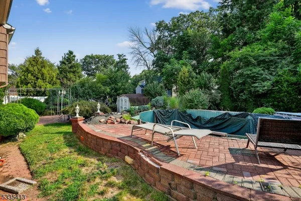 an aerial view of a house with garden space and street view