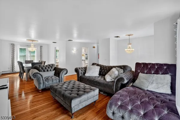 a living room with lots of furniture and wooden floor
