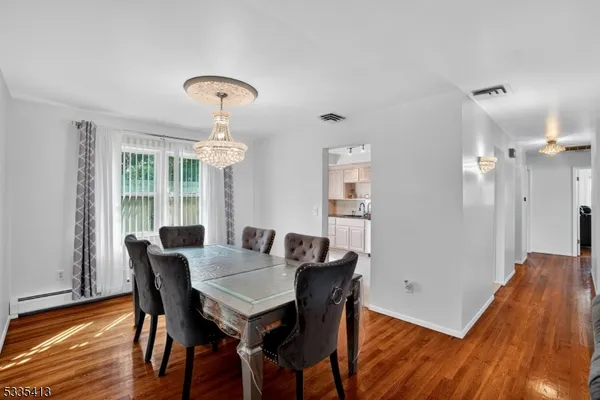a view of a dining room with furniture window and wooden floor