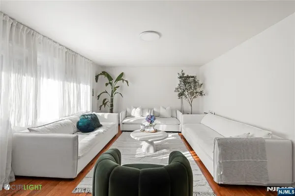 a dining room with furniture and a window