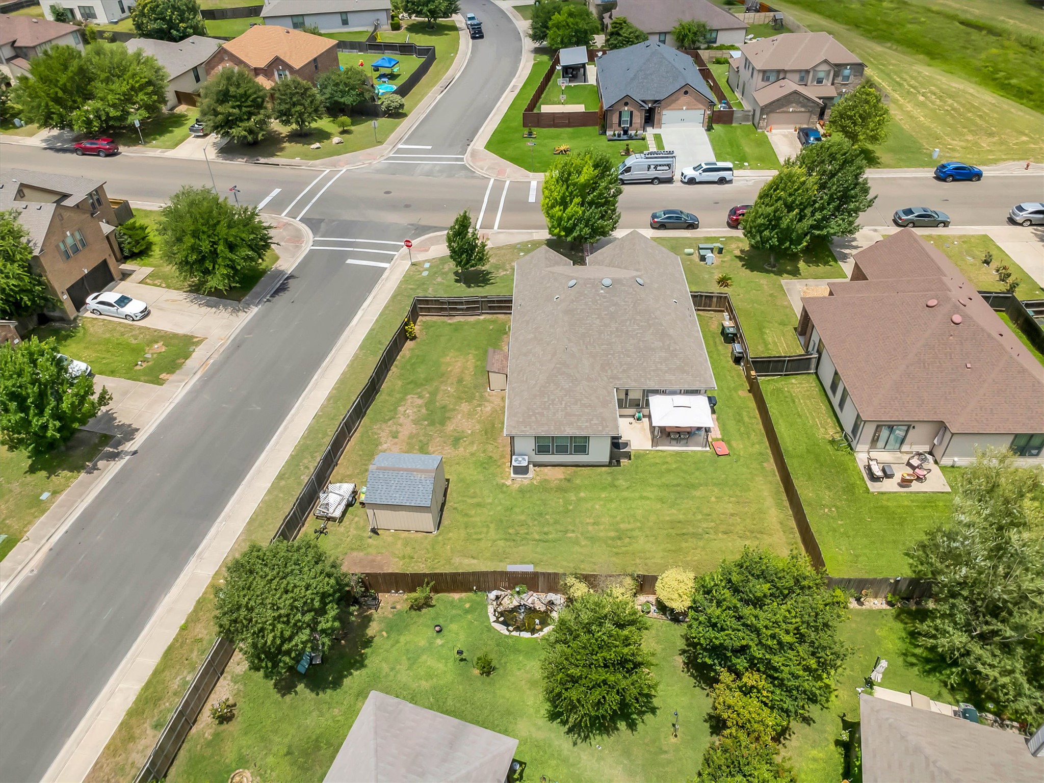 460 Waterleaf Boulevard Kyle, TX 78640 - Photo 28 of 30 A lush green yard surrounds this inviting home, complete with a garden shed and charming pond.