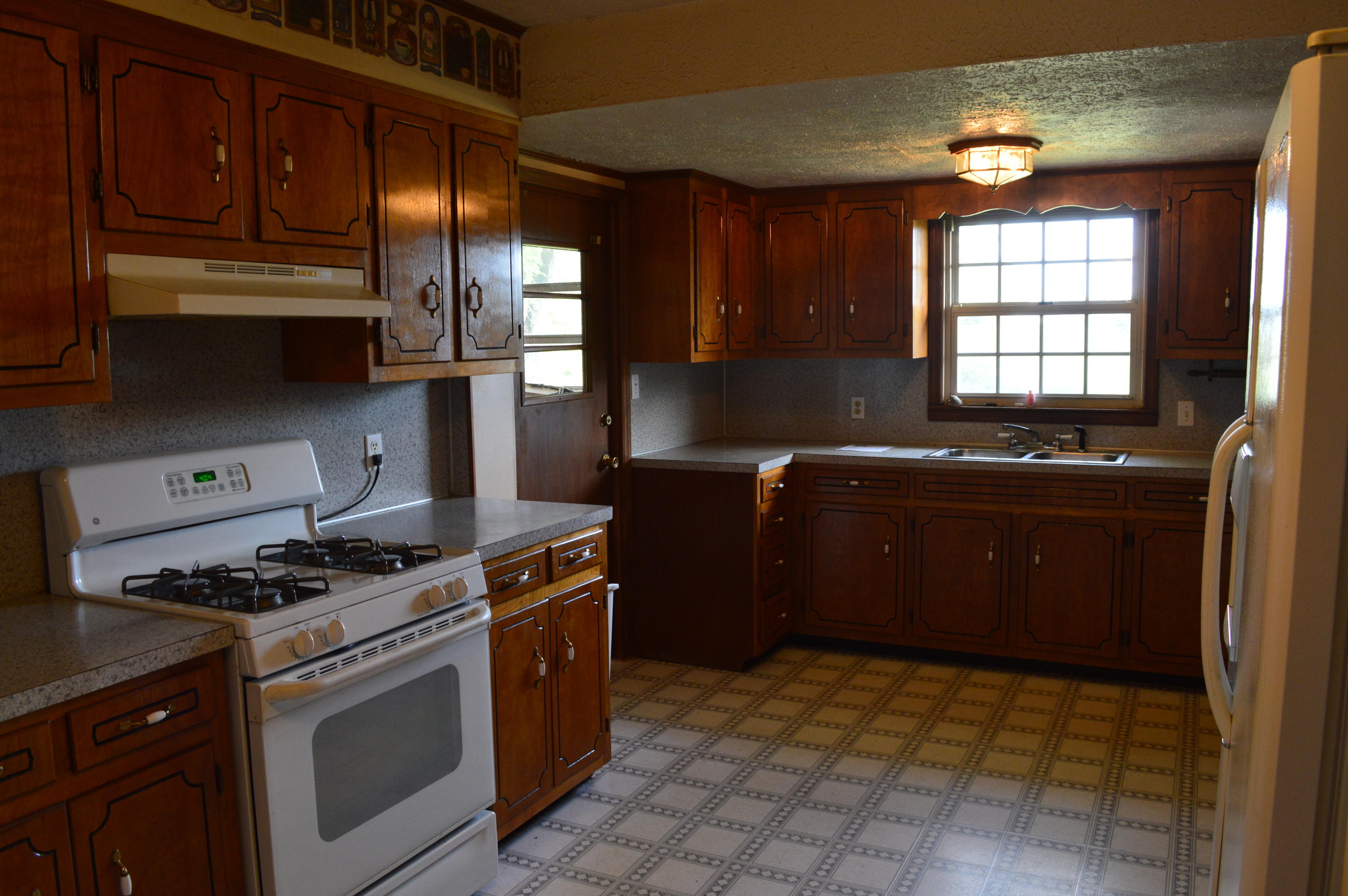 8745 Callands Road Chatham, VA 24531 - Photo 11 of 37 a kitchen with stainless steel appliances granite countertop a stove a sink and a refrigerator